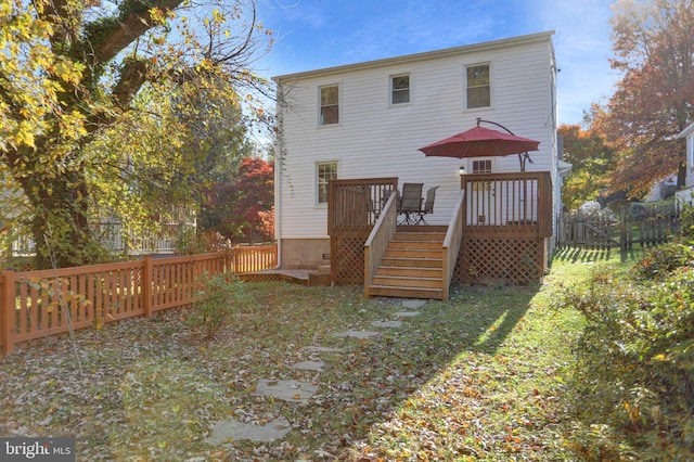 back of property with a wooden deck