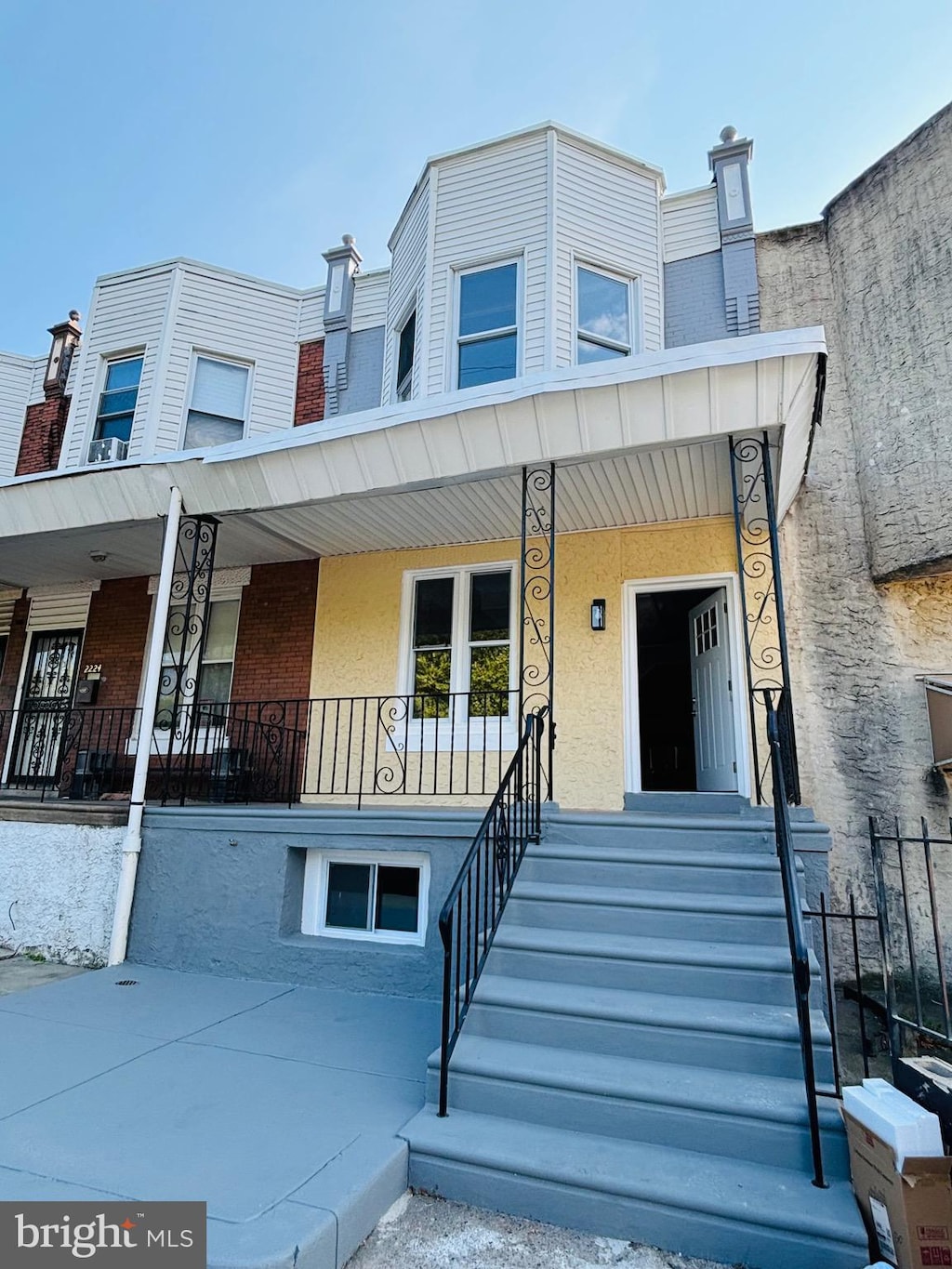 view of property featuring covered porch and stucco siding