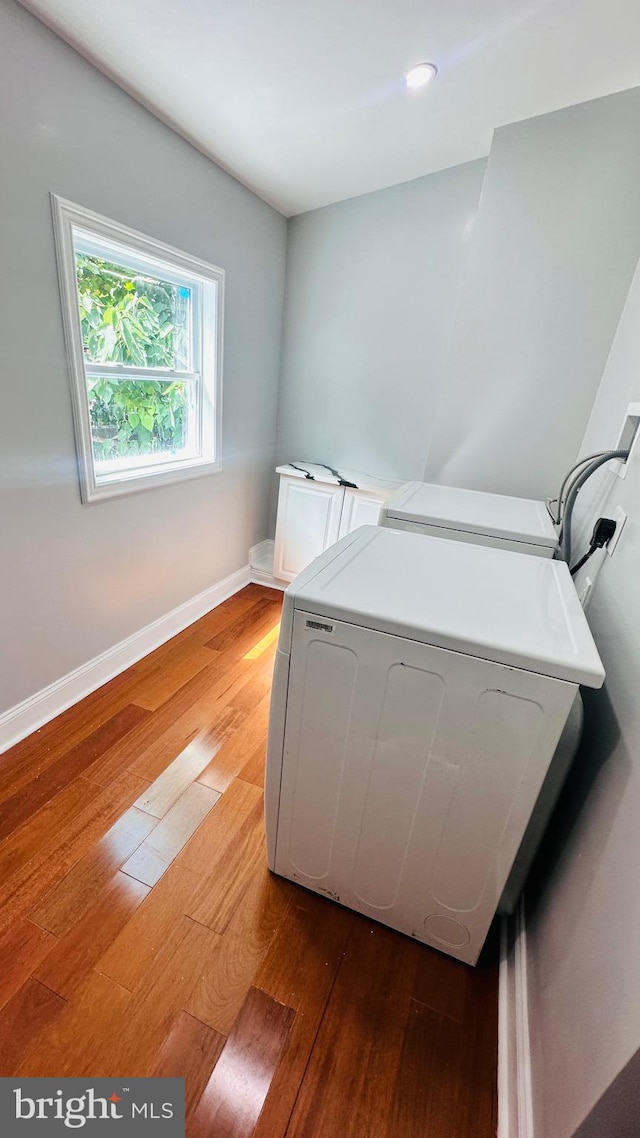 bedroom featuring hardwood / wood-style floors and washer and dryer