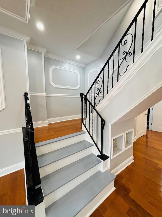 staircase with hardwood / wood-style flooring