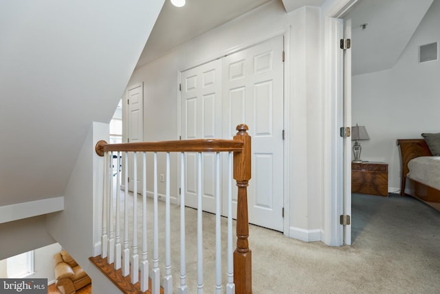 stairway featuring carpet, visible vents, and baseboards