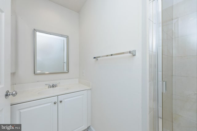 bathroom with a shower stall and vanity