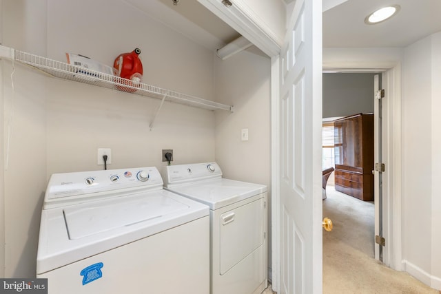 clothes washing area featuring laundry area, independent washer and dryer, and light colored carpet