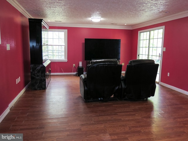 living room with a textured ceiling, dark wood-type flooring, and a healthy amount of sunlight