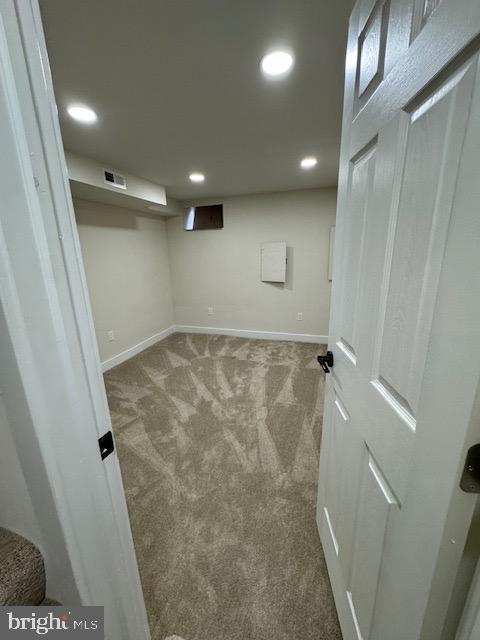 finished below grade area with carpet floors, recessed lighting, visible vents, and baseboards