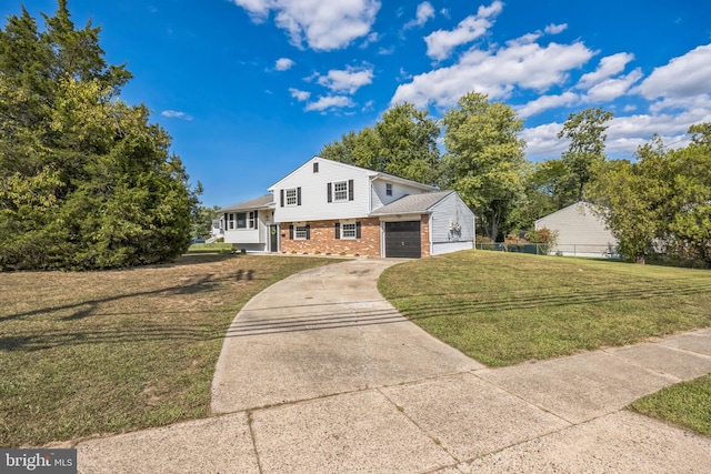 split level home featuring a garage and a front lawn