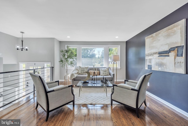 living room featuring a notable chandelier and hardwood / wood-style floors