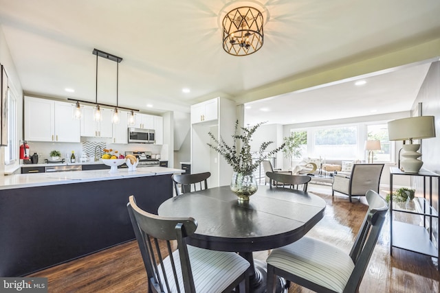 dining area with dark wood-type flooring and sink