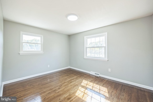 unfurnished room with hardwood / wood-style flooring