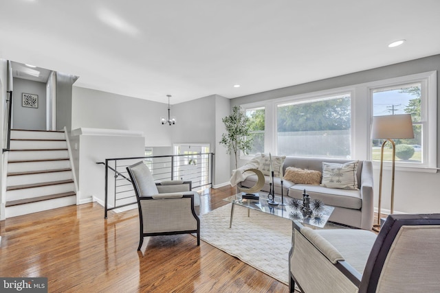 living room with a notable chandelier and light hardwood / wood-style flooring