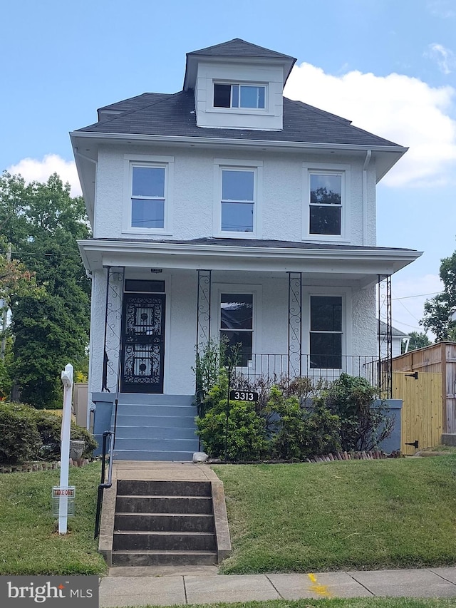 view of front facade with a porch and a front lawn