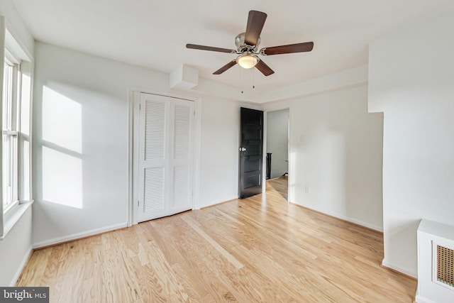 unfurnished bedroom with a closet, ceiling fan, and light hardwood / wood-style floors