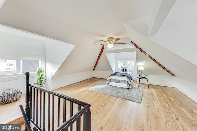 bedroom featuring multiple windows, wood-type flooring, lofted ceiling, and ceiling fan