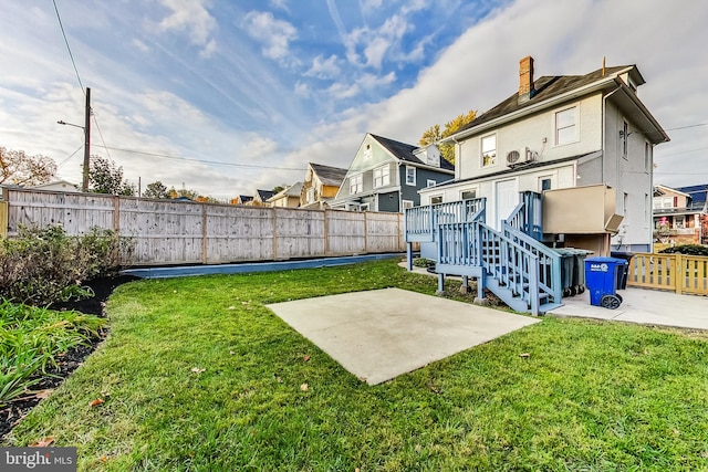 view of yard with a patio and a wooden deck