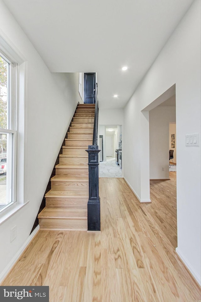 stairs with hardwood / wood-style floors