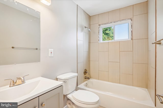 full bathroom featuring tiled shower / bath combo, vanity, and toilet