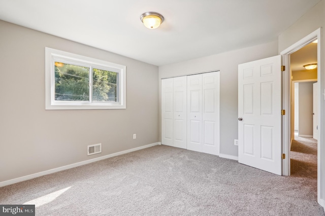 unfurnished bedroom with carpet and a closet