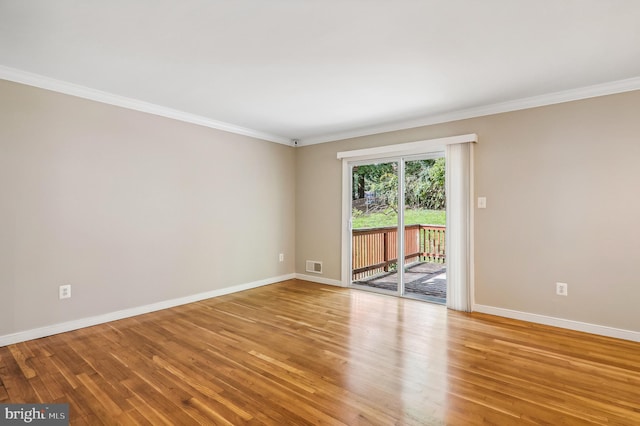 empty room with ornamental molding and light hardwood / wood-style flooring