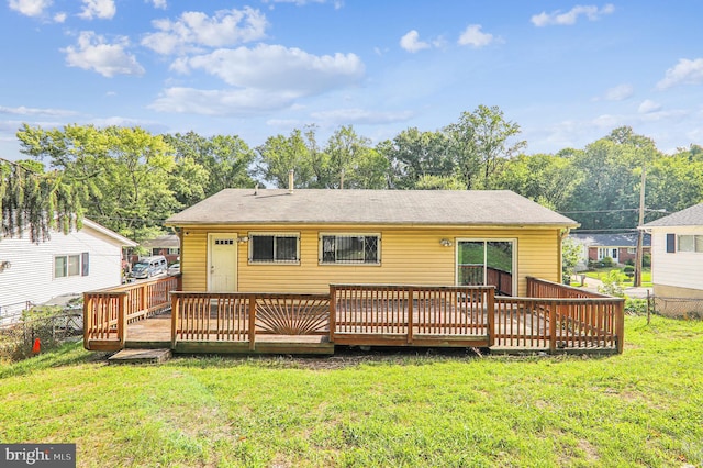 back of property featuring a yard and a deck