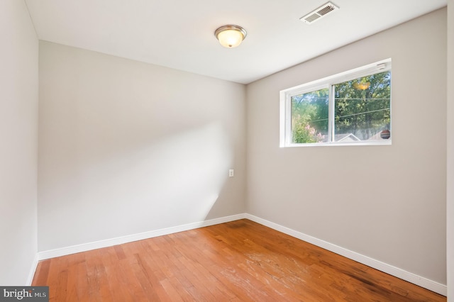 empty room with hardwood / wood-style flooring