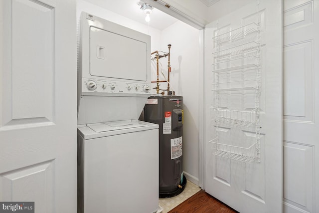 washroom with stacked washer / drying machine and water heater