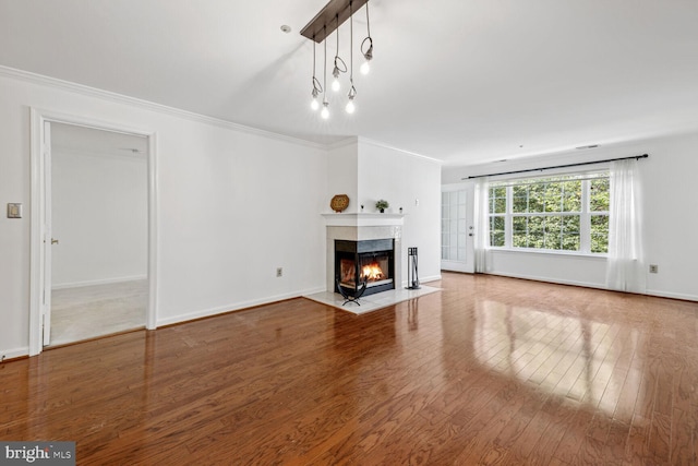 unfurnished living room featuring ornamental molding, a multi sided fireplace, and light hardwood / wood-style flooring