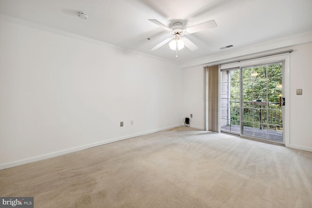 carpeted empty room featuring ceiling fan and ornamental molding