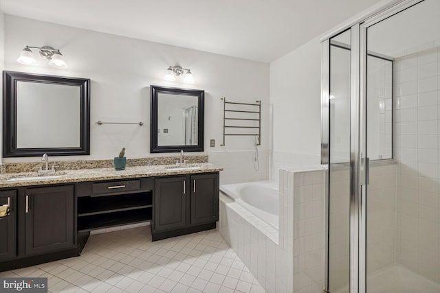 bathroom featuring plus walk in shower, tile patterned flooring, and vanity