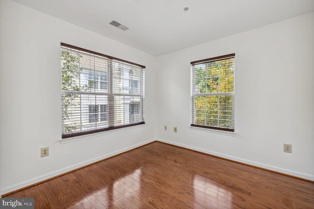 unfurnished room with wood-type flooring