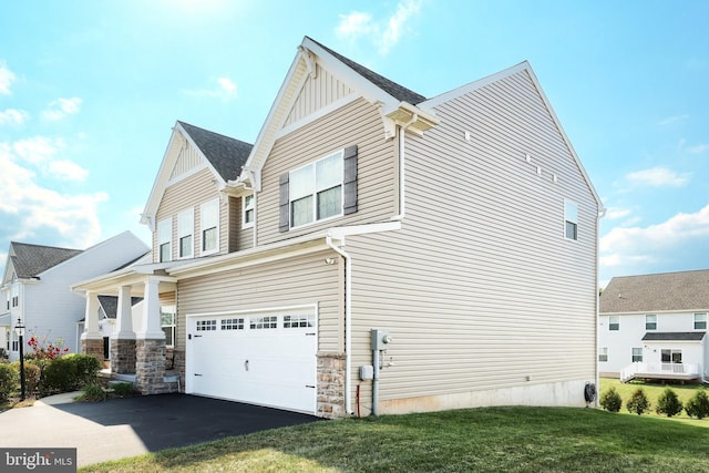 view of home's exterior with a yard and a garage