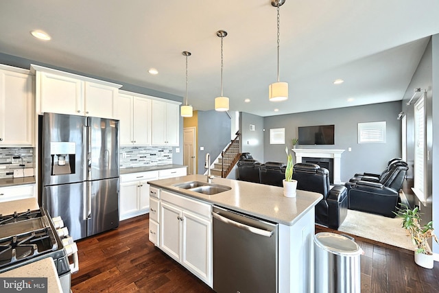 kitchen featuring white cabinets, appliances with stainless steel finishes, dark hardwood / wood-style floors, and sink