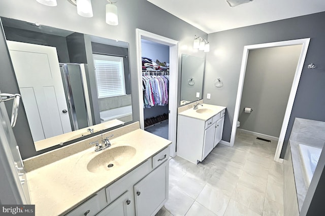 bathroom featuring vanity and shower with separate bathtub