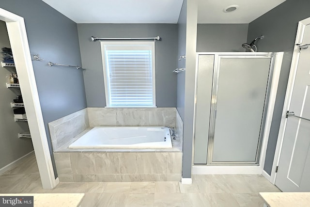 bathroom with shower with separate bathtub