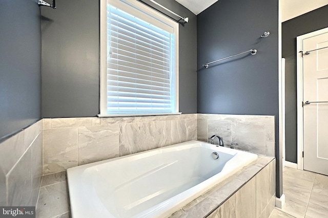 bathroom featuring a relaxing tiled tub