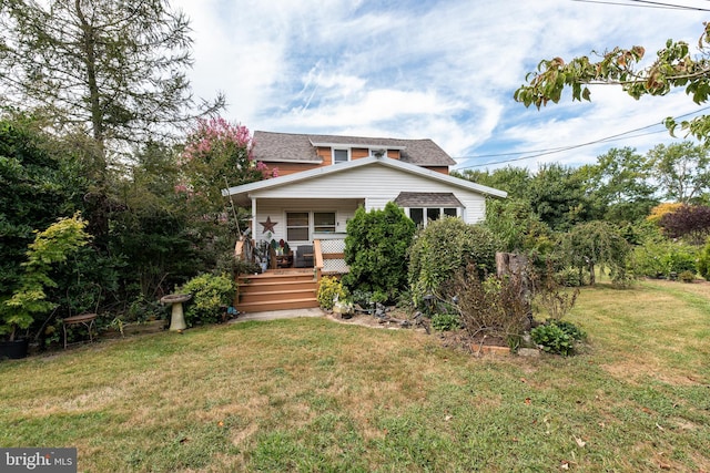 back of house with a lawn