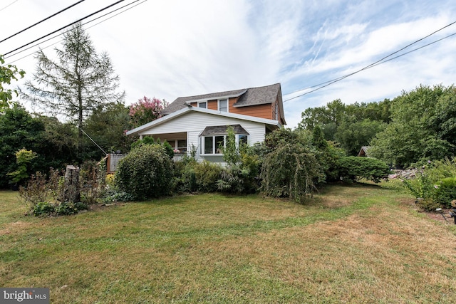 view of home's exterior with a yard