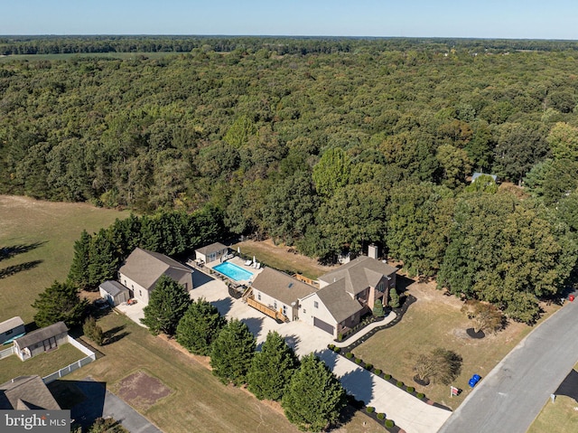 bird's eye view with a wooded view