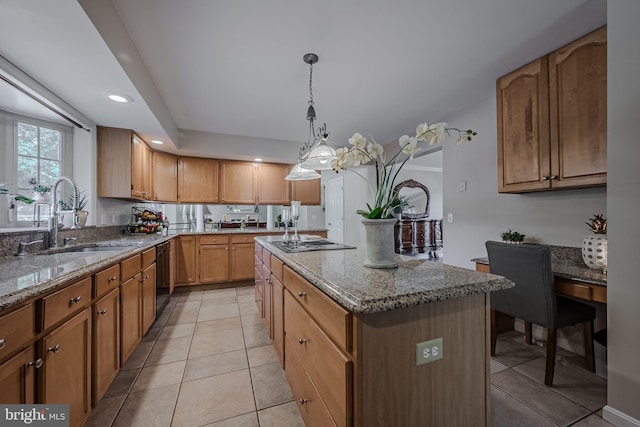 kitchen with light stone counters, a center island, sink, stainless steel gas cooktop, and black dishwasher