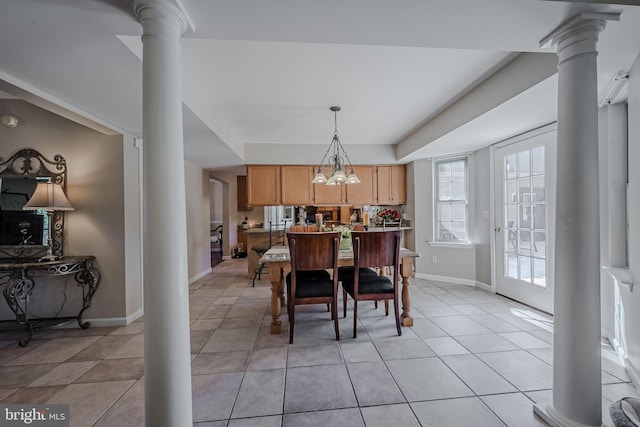 tiled dining area with decorative columns and a notable chandelier