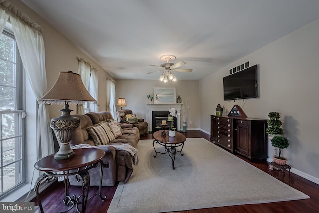 living room featuring dark hardwood / wood-style floors and ceiling fan