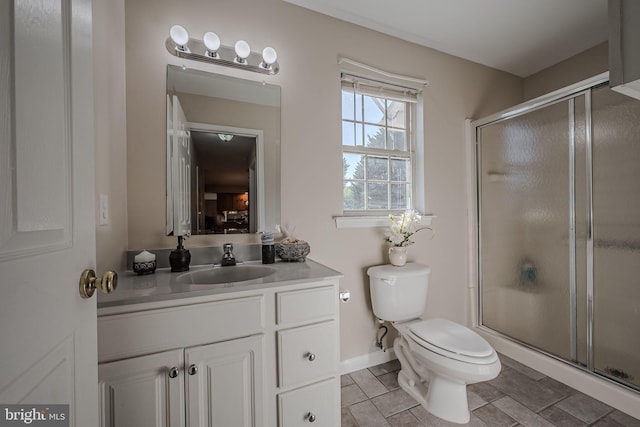 bathroom with vanity, toilet, and an enclosed shower