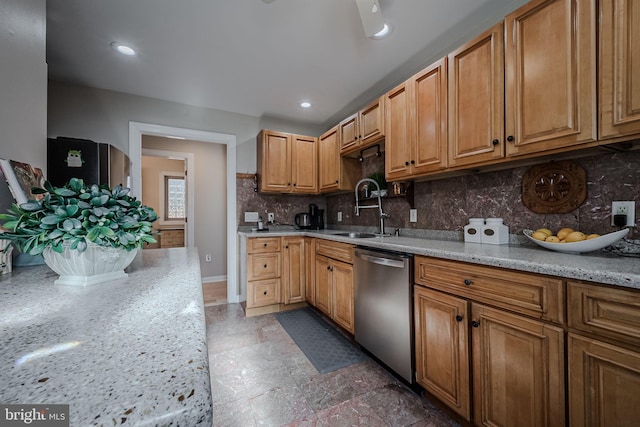 kitchen with backsplash, sink, stainless steel dishwasher, and light stone countertops