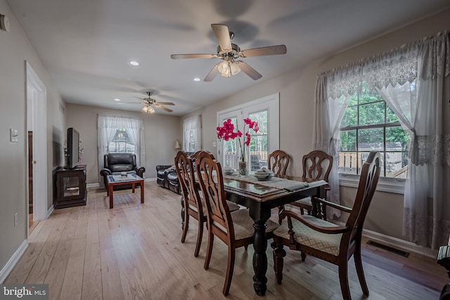 dining area with ceiling fan and light hardwood / wood-style flooring