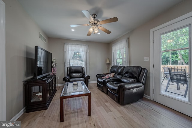 living room featuring plenty of natural light, light hardwood / wood-style floors, and ceiling fan