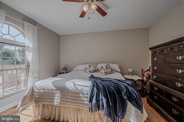 bedroom with ceiling fan and light wood-type flooring