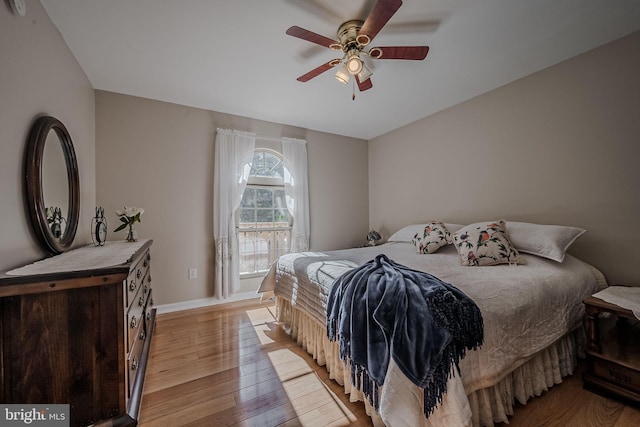 bedroom with ceiling fan and light hardwood / wood-style floors