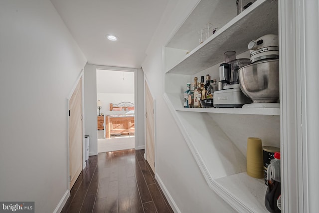 hallway with dark hardwood / wood-style flooring