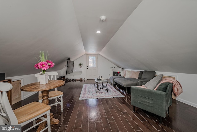 living room with vaulted ceiling and dark wood-type flooring