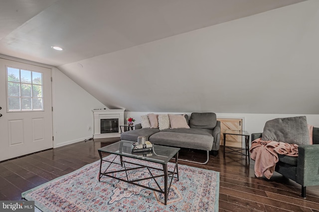 living room featuring lofted ceiling and dark wood-type flooring