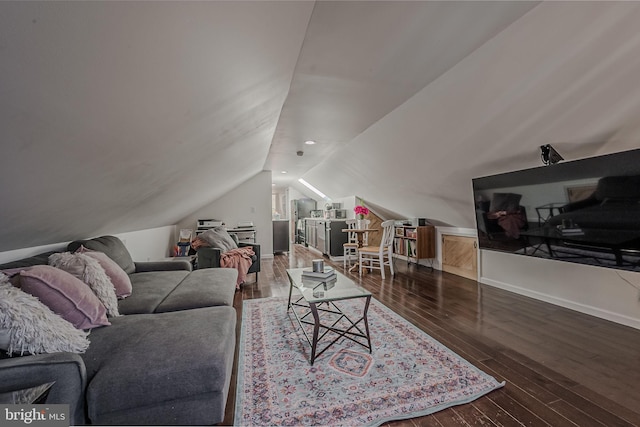 living room featuring lofted ceiling and dark hardwood / wood-style floors